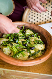 cooking fish stew in a tagine